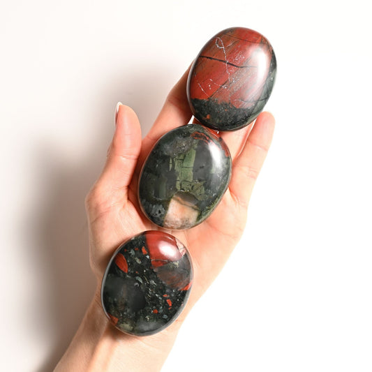 Hand holding Bloodstone Palm stone