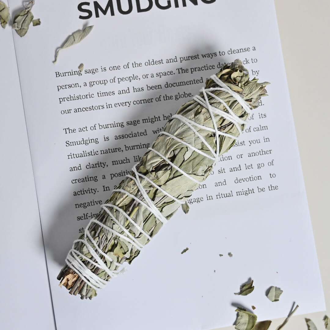 Smudge stick of Blue Sage placed on book