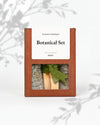 Botanical Set — Reset: terracotta Maison Éthérique box with a window showing white sage, blue sage and Palo Santo tied with green ribbon.