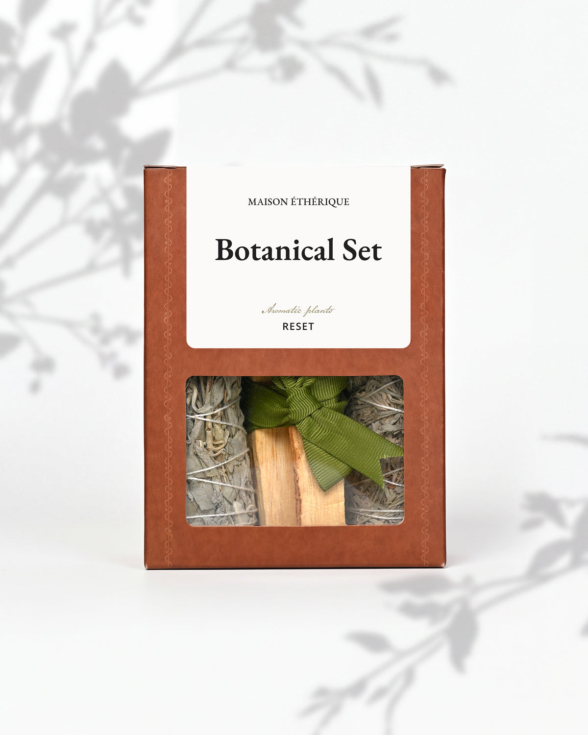 Botanical Set — Reset: terracotta Maison Éthérique box with a window showing white sage, blue sage and Palo Santo tied with green ribbon.