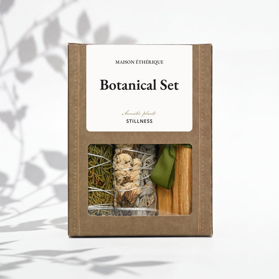 Botanical Set — Stillness: olive Maison Éthérique box with a window showing juniper, white sage and Palo Santo tied with green ribbon.