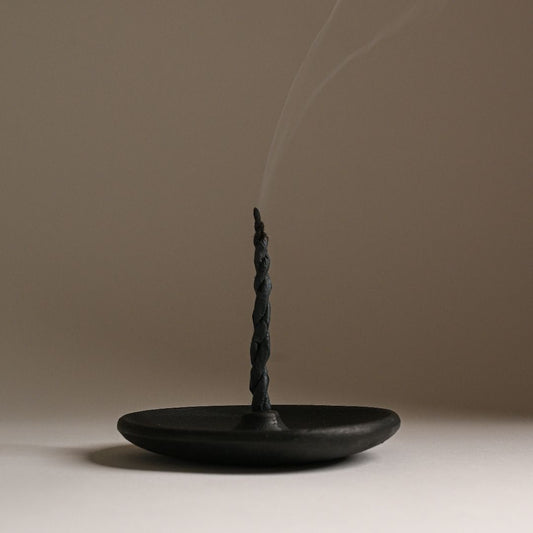 Rope incense stick on a clay plate