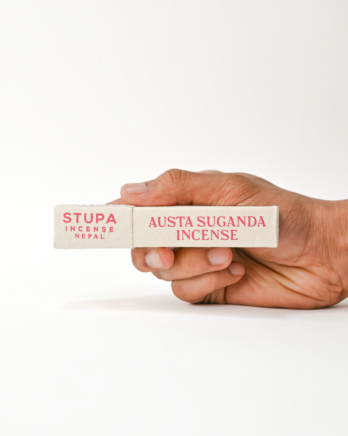 Hand holding Austha Suganda Incense