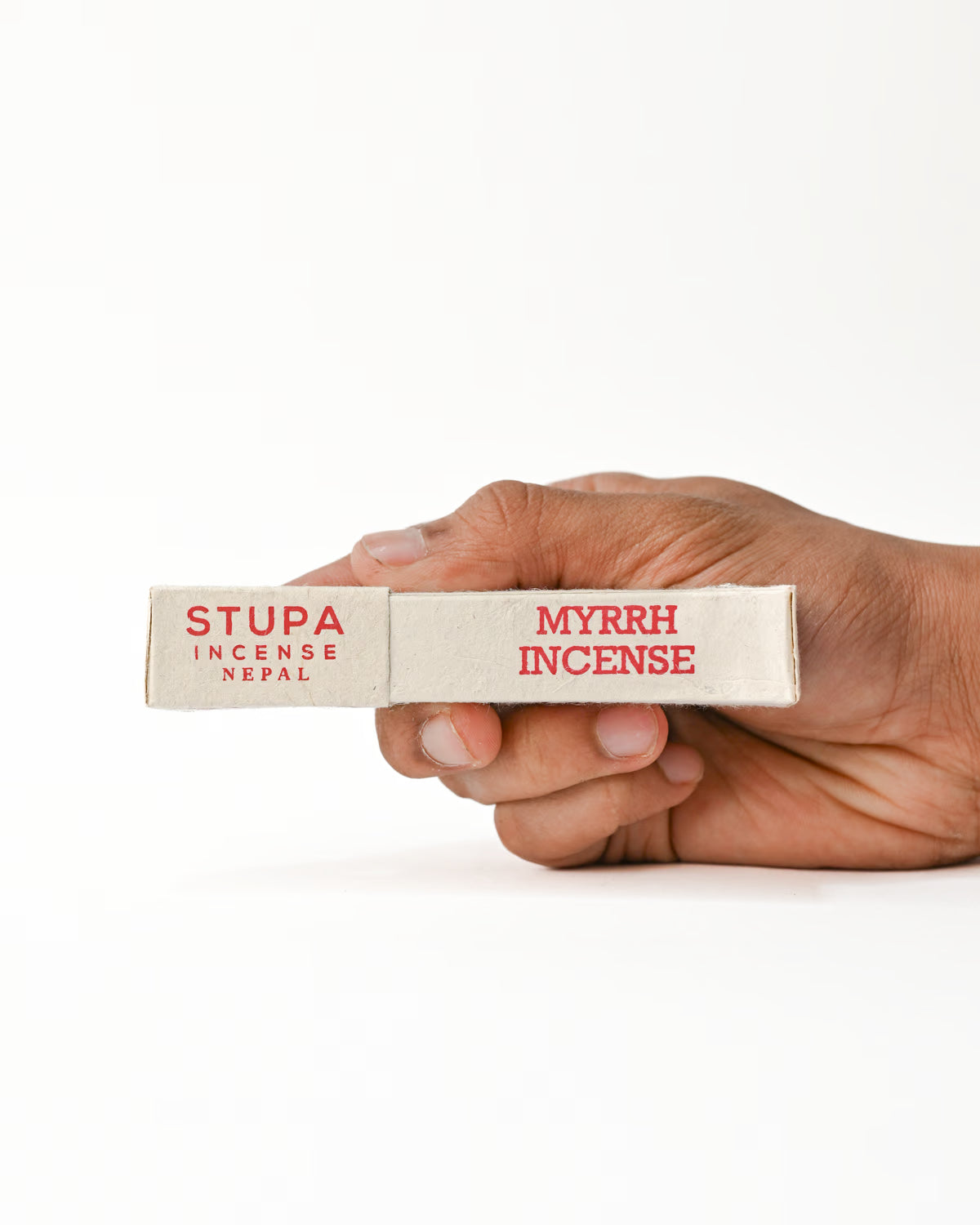 Hand holding Myrrh Incense
