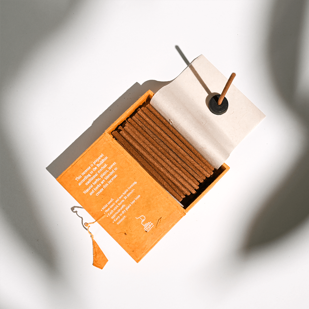 Open box of Himalayan Cedar incense sticks by Maison Etherique on a wooden table, promoting tranquility and mindfulness.