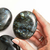Labradorite_stone_holding_on_hands_332406fe-a3e7-4159-9572-87c97f0c5419 - Maison Éthérique