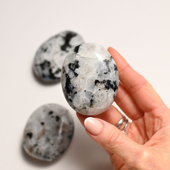 Hand holding the Rainbow Moonstone