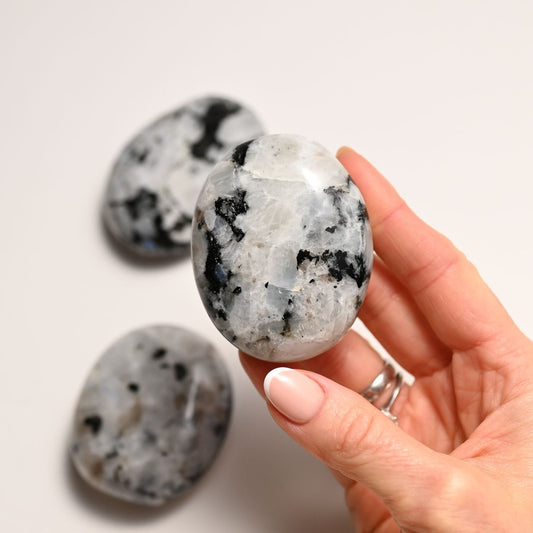 Hand holding the Rainbow Moonstone