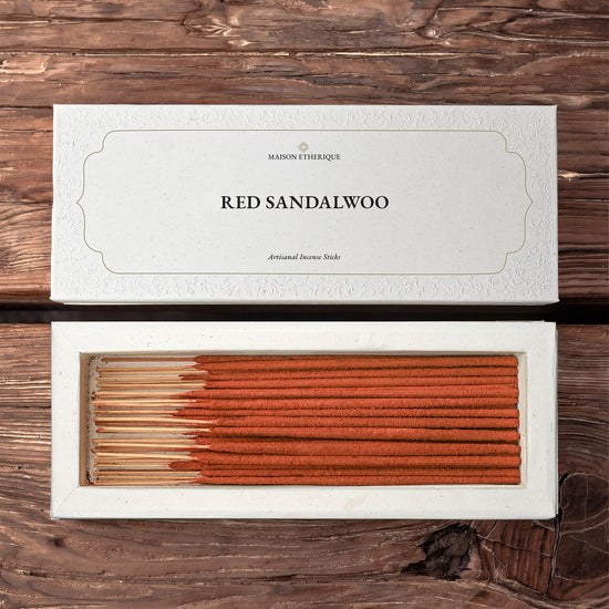 Red Sandalwood incense sticks: Maison Éthérique white box lid above the open box of red-brown sticks, on a wooden surface.