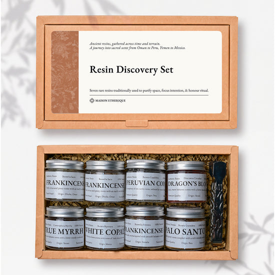 Resin Discovery Kit: kraft box lid above the open box with eight small labelled jars of resin and a pair of metal tongs.