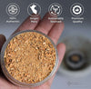 A jar of palo santo powder shown by hand
