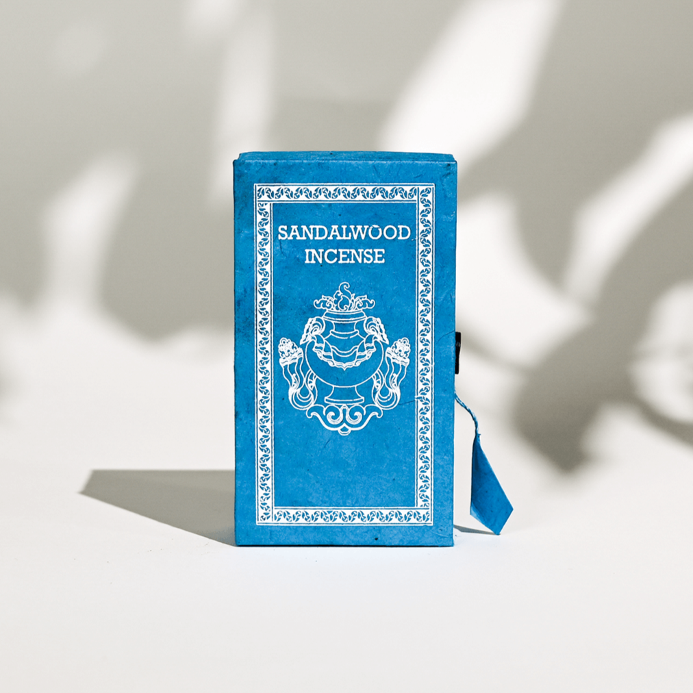 A blue box containing Sandalwood Stupa incense sticks, handcrafted in Nepal.