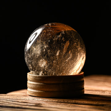 Crystal on a wooden stand with a dark background