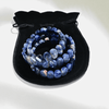 Sodalite Bracelets placed on top of a black pouch 