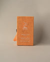 Back of an orange paper box of Stupa Himalayan Cedar incense sticks, handmade in Nepal, on a pale background.