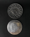 Front and plain back of the Eye of Horus metal incense holder, one above the other on a dark background.