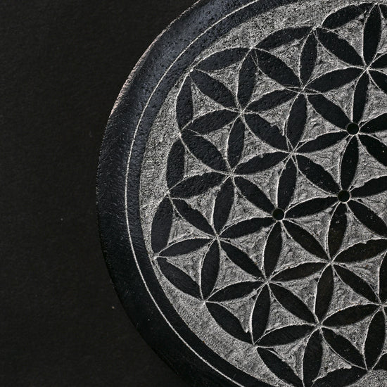 Close view of the Flower of Life pattern carved into the stone incense holder.
