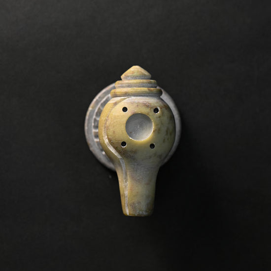 Shankh stone incense holder seen from above, showing the holes for incense sticks.