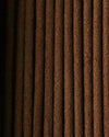 Close view of Nag Champa incense sticks laid side by side, showing their dark brown texture.