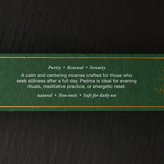 Side of the green Padma Tibetan incense box with printed gold text, on a dark background.