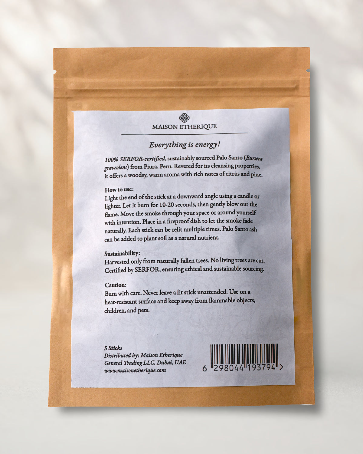Back of a Maison Éthérique kraft pouch of five Palo Santo sticks, showing the printed label with instructions and barcode.