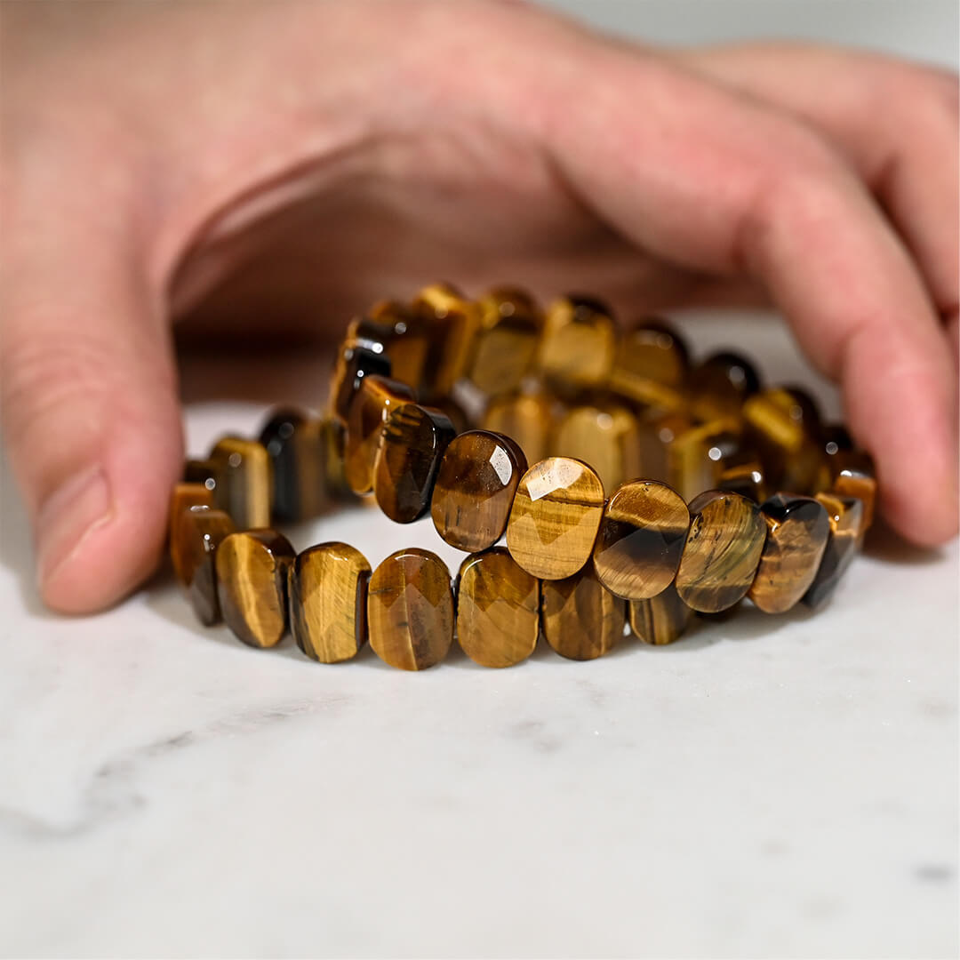 Tiger-eye-bracelets-stacked-held-with-a-hand