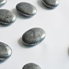 Hematite Palm Stones on White surface