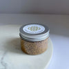 A jar of Palo Santo Powder on a marble wedge