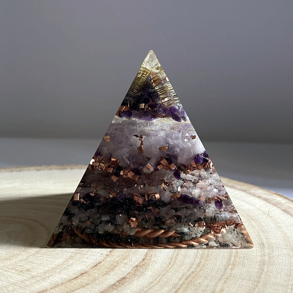 A displayed Orgonite Pyramid - Balance and Protection on a wedge