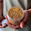 Load image into Gallery viewer, A man showing a jar of Palo Santo Powder 