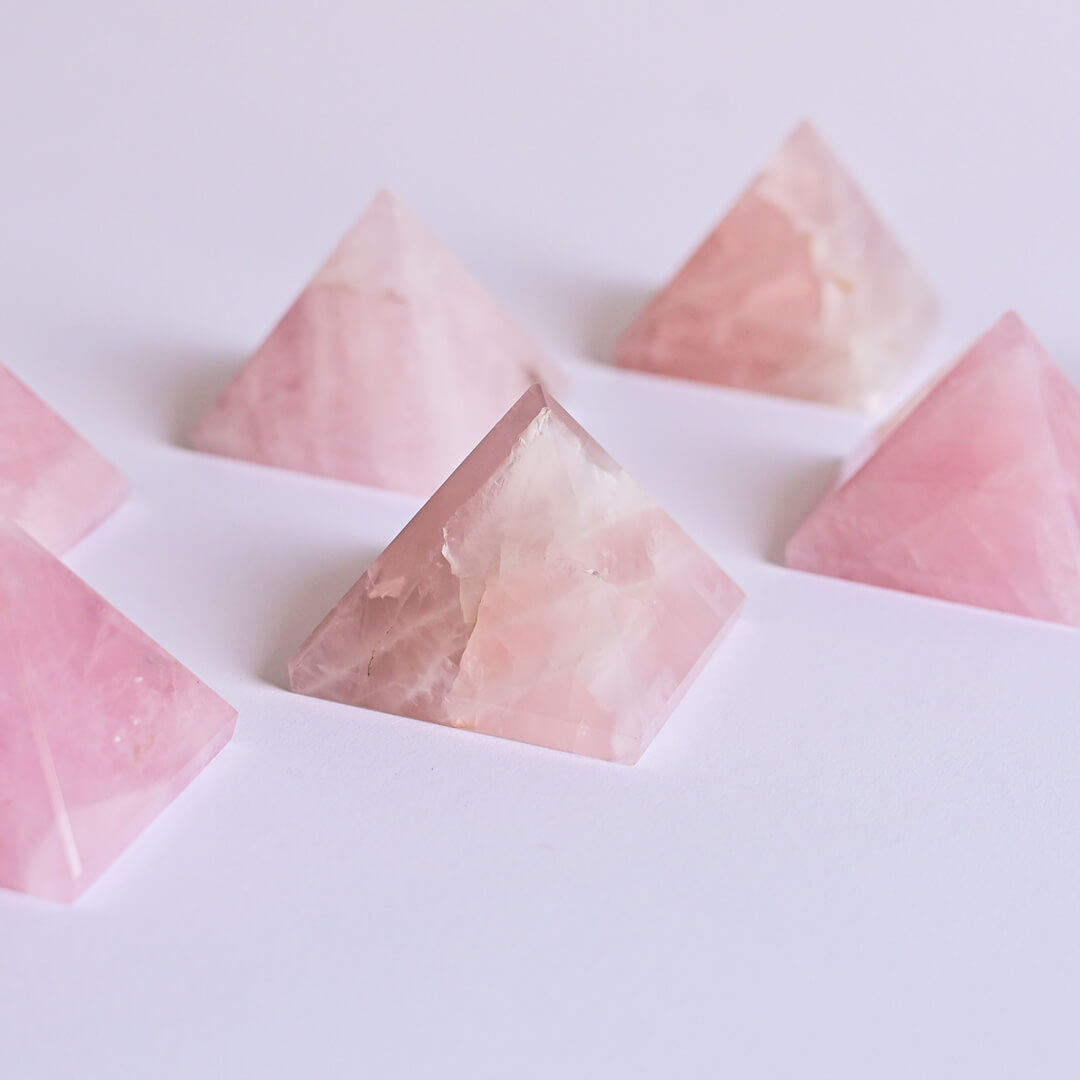 Rose Quartz Pyramids on white surface