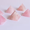 Rose Quartz Pyramids on white surface