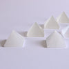 Selenite Pyramids placed on white surface