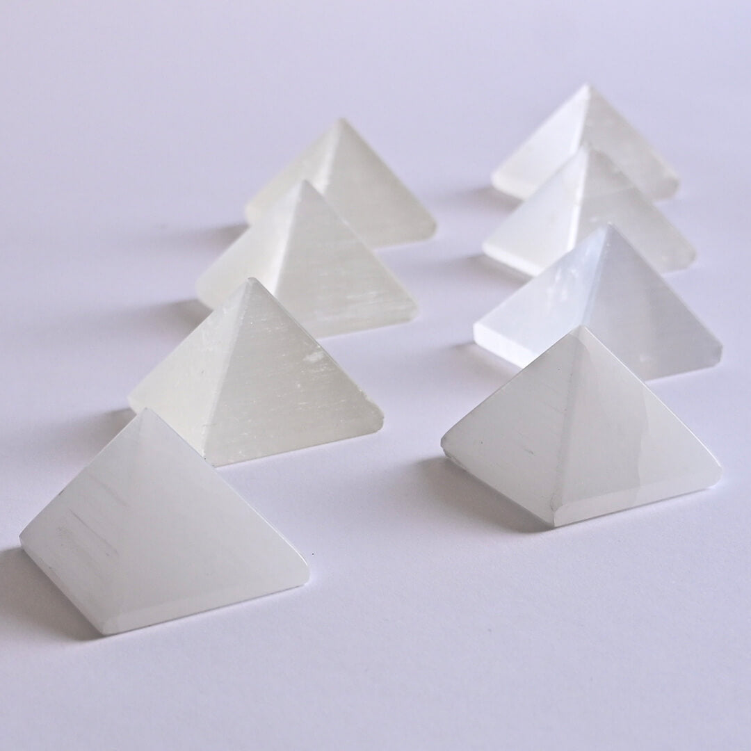 Selenite Pyramid placed on white surface
