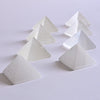 Selenite Pyramid placed on white surface