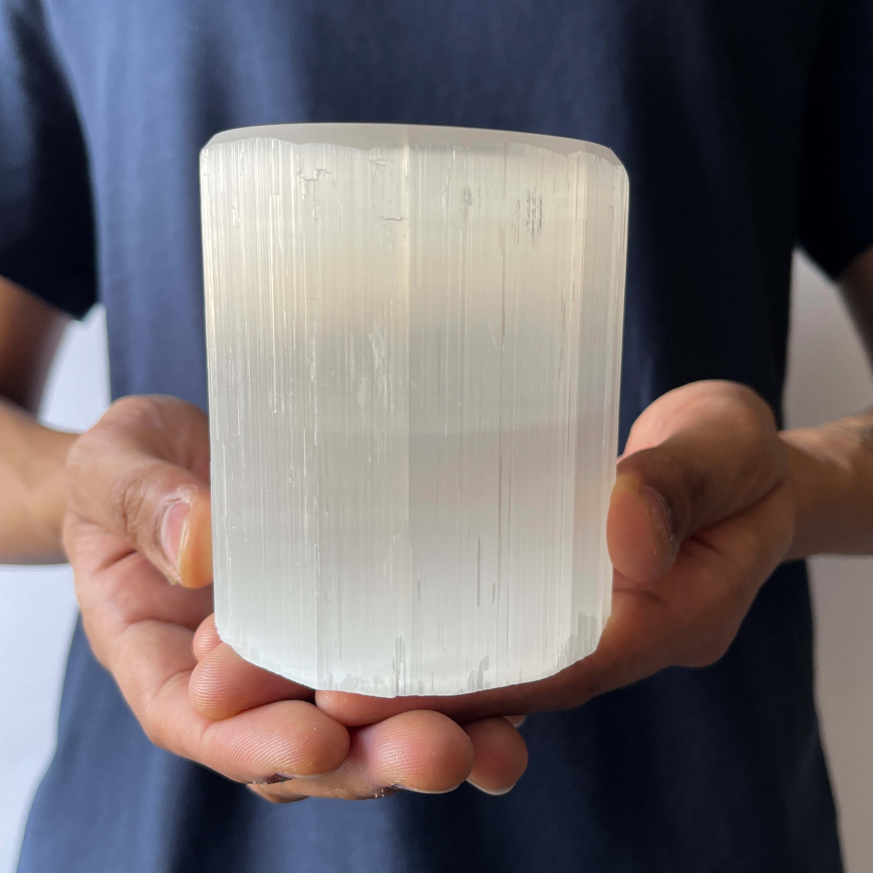 A person holding a Selenite Crystal Candle Holder 