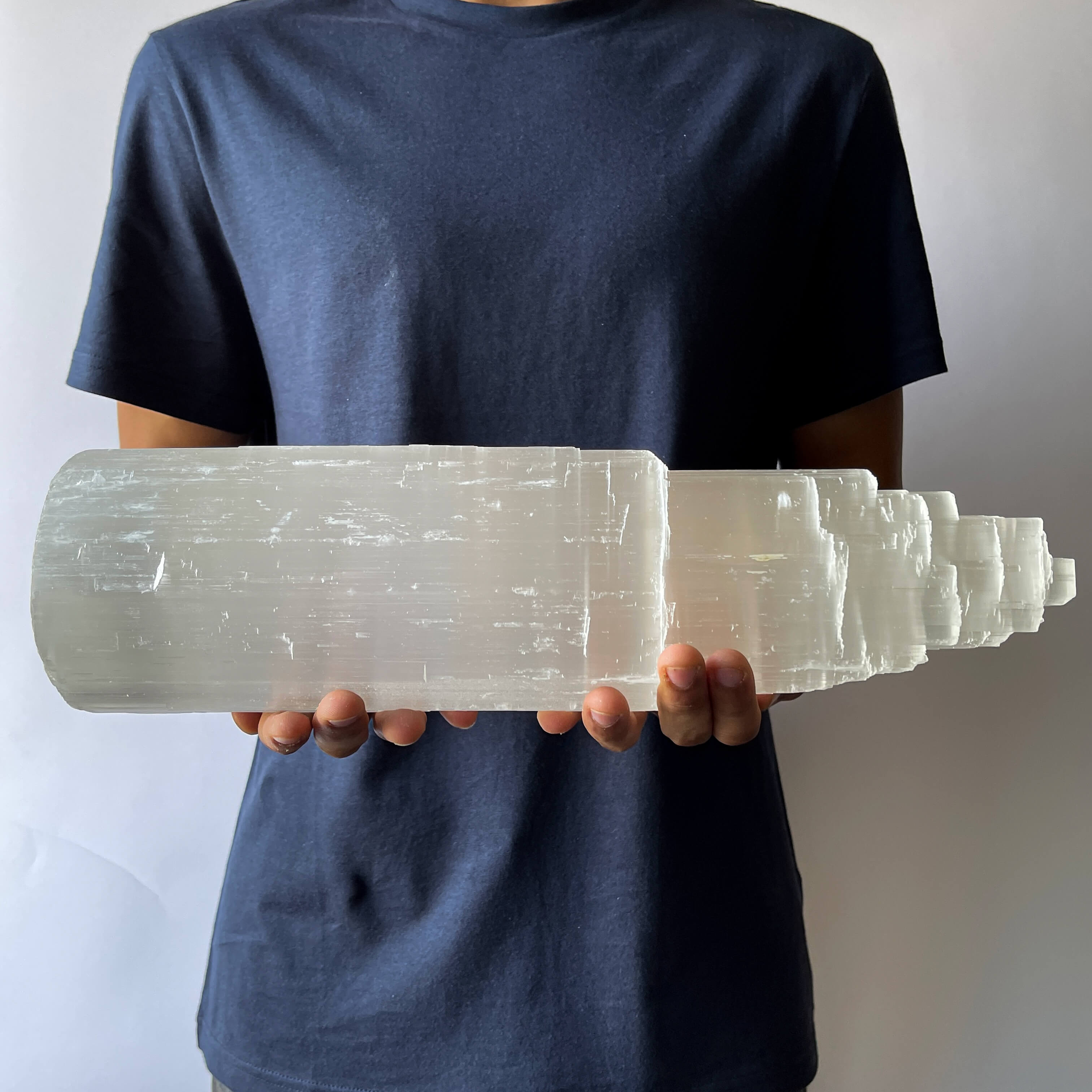 A man showing A Selenite Crystal Tower - 40cm 