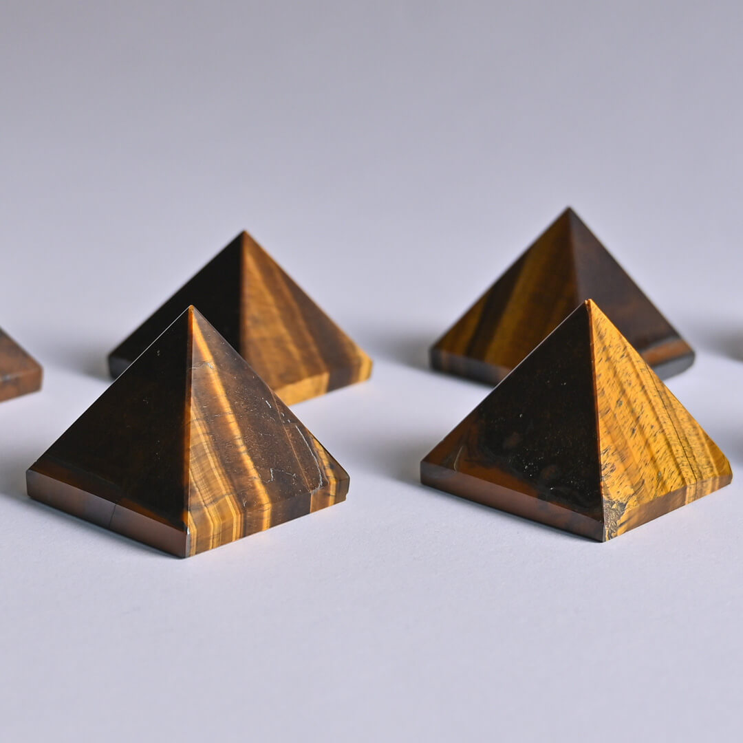Tiger's Eye pyramid placed on white surface