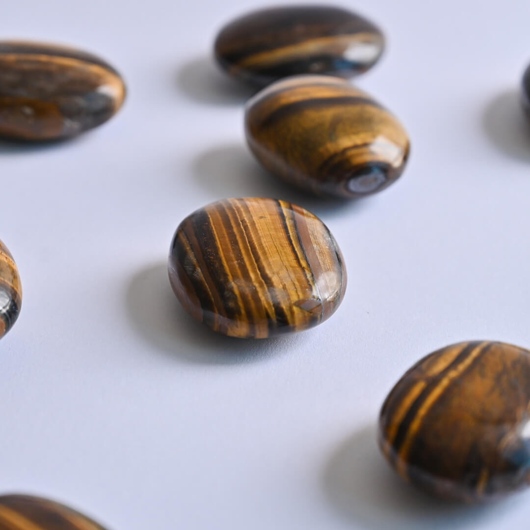 Tiger's Eye Palm Stones on white surface