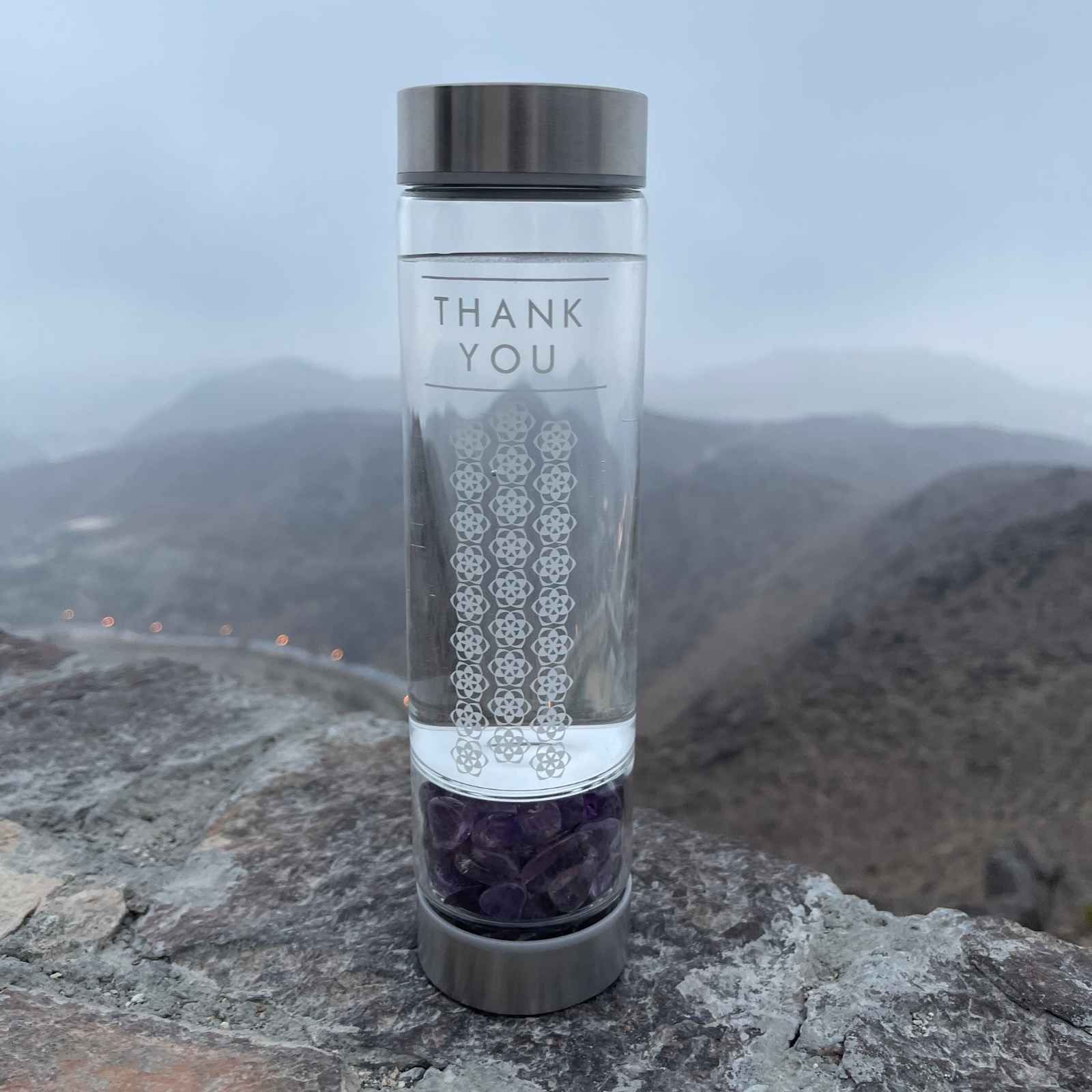 A Water Crystal Bottle of a tumbled Amethyst on top of the mountain